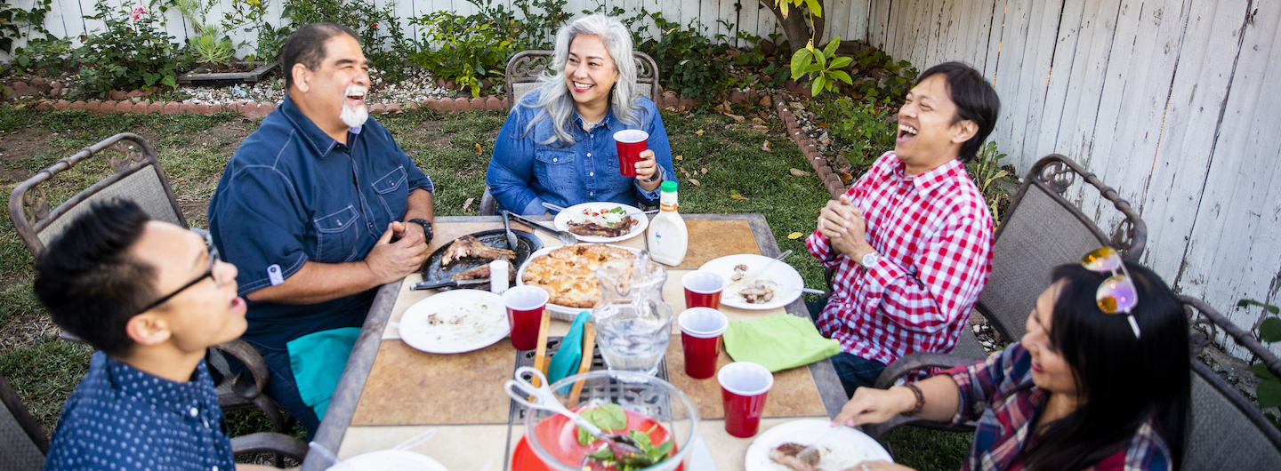 extended family eating outside at a table