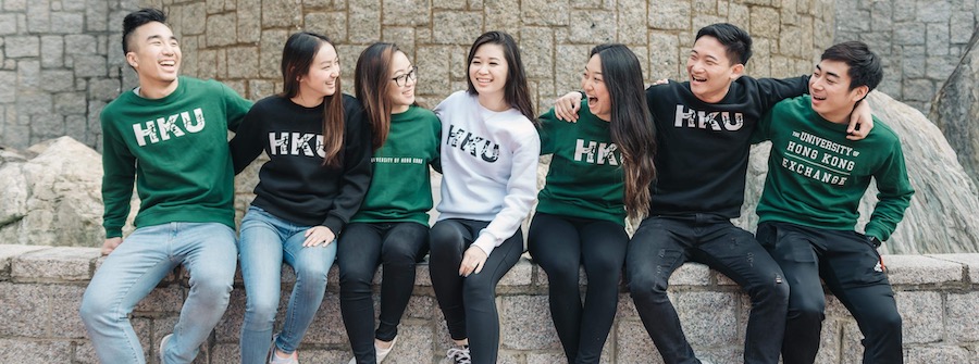2 of 2, UCEAP student Rainey Hang Chak poses with her fellow students while wearing HKU merchandise